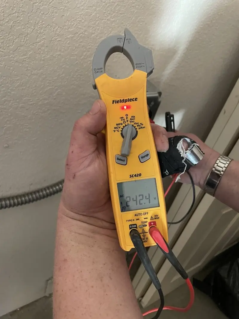Voltage testing with clamp meter during Outlet Installation in Moscow